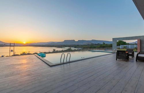 Nashik Villa | StayVista's Bellisimo Panorama - Lakeside Oasis with Infinity Pool, Modern Interiors, Open-to-Sky Bathtub, and Lush Green Lawn