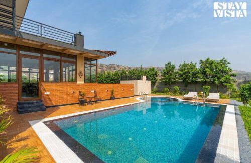 Gurugram Villa | StayVista's Shivoham Farms - Mountain-View Villa with Outdoor Pool, Lawn, and Terrace