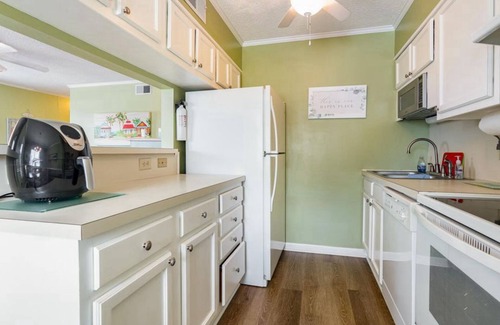 Ocean Drive Condo | Steps to the beach, outdoor pool, and 10 minute walk to Main St. attractions.