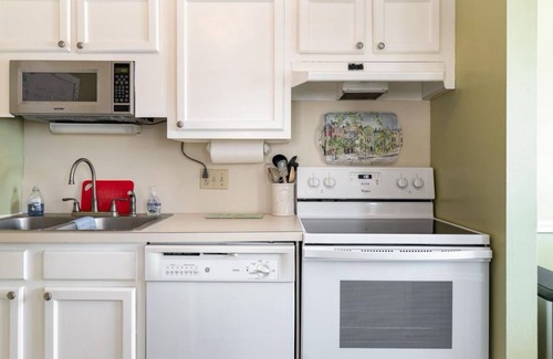 Ocean Drive Condo | Steps to the beach, outdoor pool, and 10 minute walk to Main St. attractions.