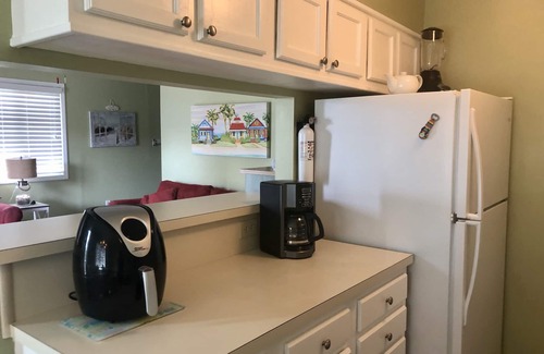 Ocean Drive Condo | Steps to the beach, outdoor pool, and 10 minute walk to Main St. attractions.