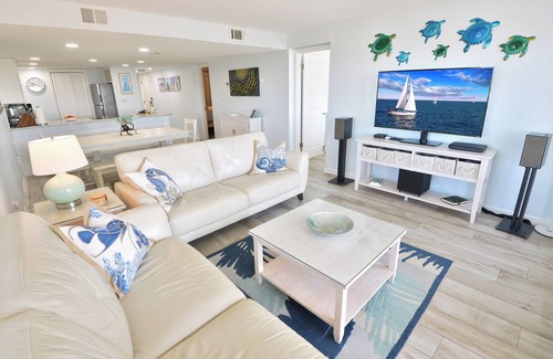 Sunnyside Condo | Steps to the beach with wrap-around ocean-front balcony