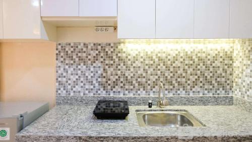 Surabaya Apartment | Strategic and Cozy Living Studio at Bale Hinggil Apartment By Travelio