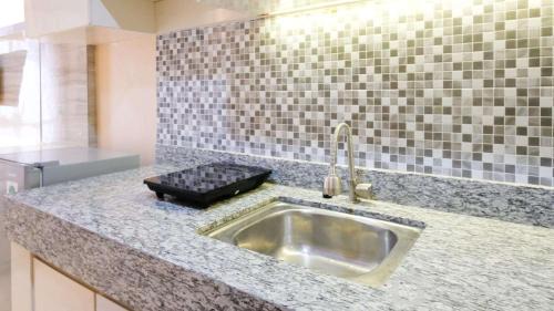 Surabaya Apartment | Strategic and Cozy Living Studio at Bale Hinggil Apartment By Travelio