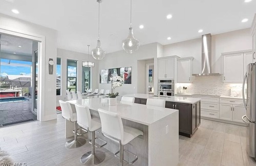 Pelican Villa | Stunning New Waterfront Luxury Villa with oversized Heated pool and Hot tub!