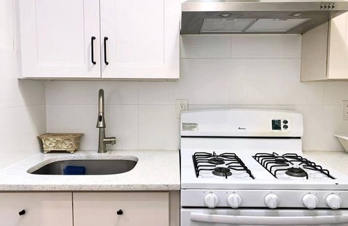 East Flushing House | Stylish 3-bedroom House with Skylight and Access to Rooftop Deck and Patio