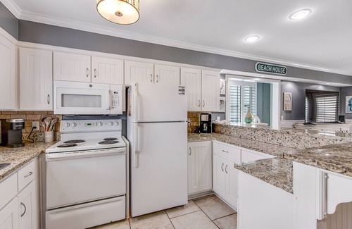 Holiday Isle Condo | Stylish waterfront condo with pools, hot tubs, private beach, & sports courts