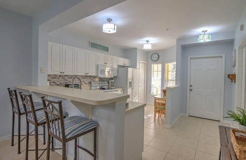 Ole Condo | Sunny Coral Falls With Vibrant Tropical Colors