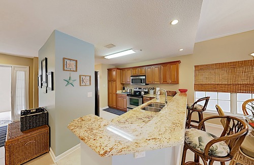 Butler Beach Condo | Sunny Poolside Condo w/ Patio: Hot Tub & Beach Access, Near Shopping & Dining