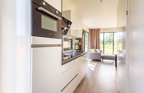 Kotten House | The 6-person holiday villa Amalia with a private sauna has a spacious living room, an open kitchen, three bedrooms, and a spacious terrace.