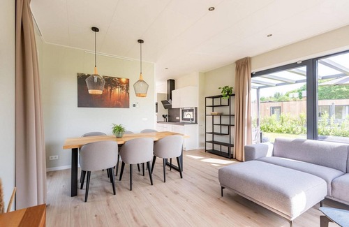 Kotten House | The 6-person holiday villa Amalia with a private sauna has a spacious living room, an open kitchen, three bedrooms, and a spacious terrace.