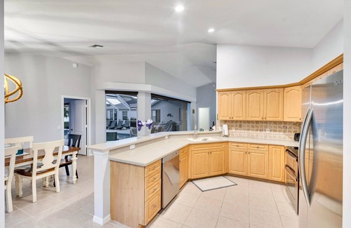 Central Naples House | This 3/2 home enjoys a Southwest facing lakefront view with pool and spa