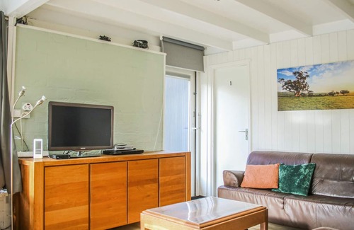 Rekem House | This beautifully situated vacation home is located in a wooded area in a welcoming vacation park nea