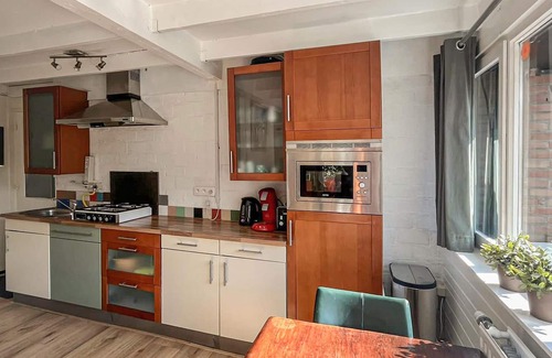 Rekem House | This beautifully situated vacation home is located in a wooded area in a welcoming vacation park nea