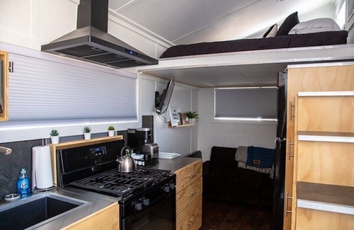 Meeker House | This Tiny Home is custom made by a Colorado craftsman has one Queen bed in loft accessible by stairs and also has a fold out Full futon on main level. Sleeps up to 4. Please note, this home does have a sleeping area in a loft. If you require an accom