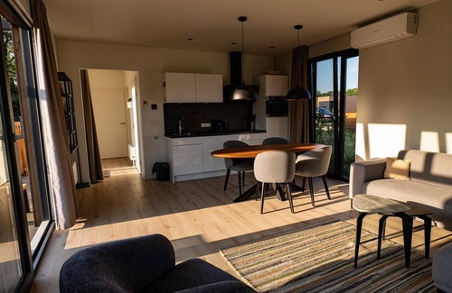 Kotten House | This vacation home, with a private sauna and hot tub, has a cozy homey living room with an open kitchen, 2 bedrooms, and generous outdoor space.