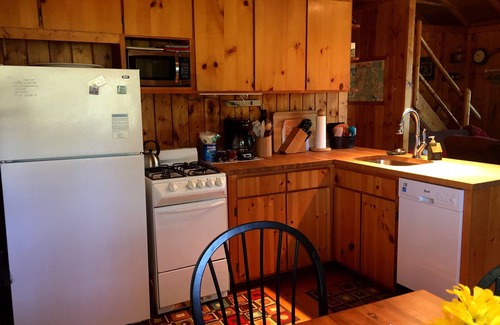 South Boardman Cottage | Traverse City area Lakefront Log Home, FREE Hot Tub, WIFI, & Boats.