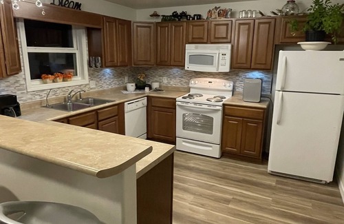 Coffeyville House | Trendy home with a scenic back porch, fish, golf and more