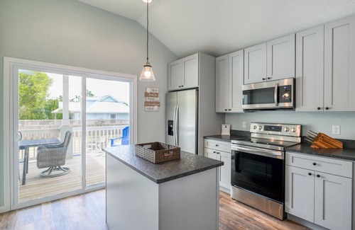 Butler Beach House | Tropical Winds - Heated Pool & Firepit! Walk to the Beach!