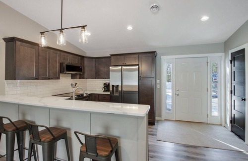 Cumberland Condo | Up North Living! Fully renovated one-level living home in wooded lot near lake.