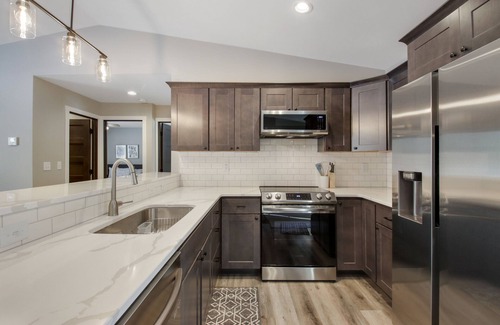 Cumberland Condo | Up North Living! Fully renovated one-level living home in wooded lot near lake.