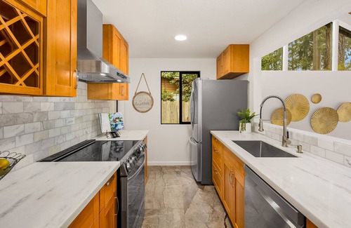 Rollingbay House | Updated beachfront home with private beach, water views, spacious deck, & W/D