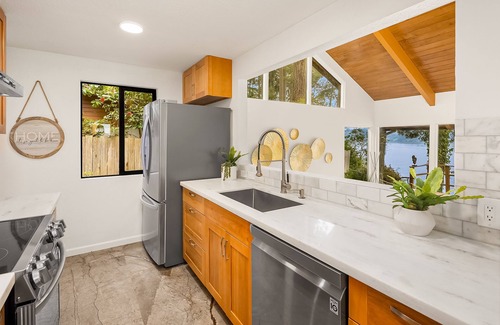 Rollingbay House | Updated beachfront home with private beach, water views, spacious deck, & W/D