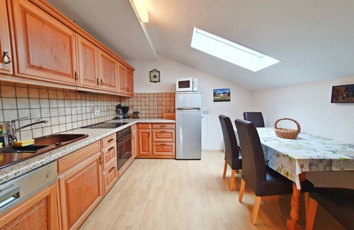 Grassau Apartment | Vacation apartment 95 sqm, for 2-5 pers., 2 bedrooms, kitchen with dishwasher, spacious living room with balcony. Living room, balcony.