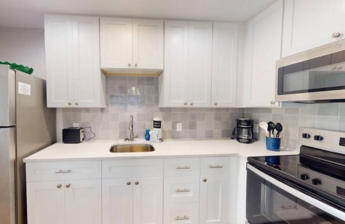 Madeira Beach Condo | Walk to Beach & Johns Pass Village! Community Heated Pool ~ Private Patio ~ Free Parking & Amenities