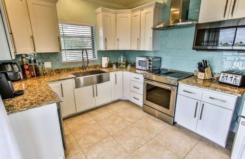 Key Colony Beach House | Watch dolphins play in Shelter Cove while swimming in our oversized pool