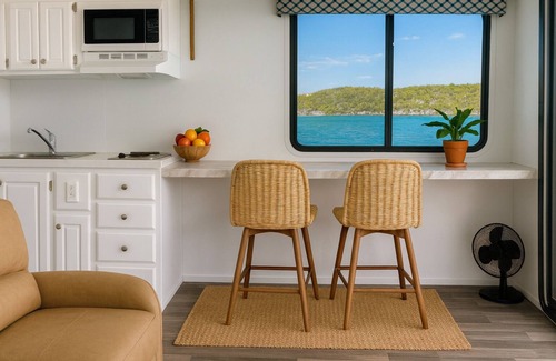 George Town Boat Rental | Water Glamping over turquoise blue water.