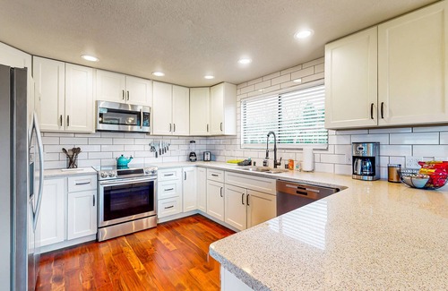 West End House | Water-view home with ADU, gated entry, hot tub, enclosed yard, deck, & 2 W/Ds