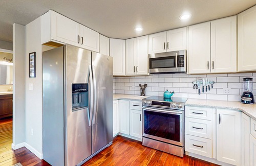 West End House | Water-view home with ADU, gated entry, hot tub, enclosed yard, deck, & 2 W/Ds