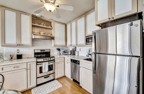 Fort Myers Beach Condo | Waterfront condo with private beach area, pool, hot tub, grills, & balcony