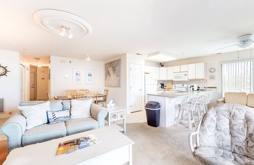 Ocean City Condo | Waterfront condo with pool, balcony, fireplace, central AC, & washer/dryer