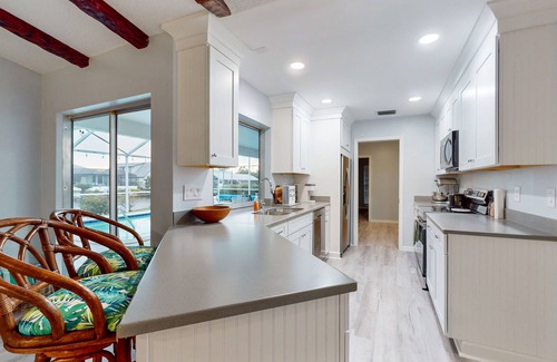 Lochmoor Waterway Estates House | Waterfront home with pool, bikes, grill, fireplace, internet, W/D, & central AC