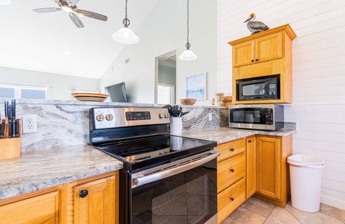 Dauphin Island House | Waterfront home with wraparound deck, BBQ, spacious interior, & W/D