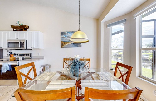 Cape Coral House | Waterfront home with screened pool, patio, grill, foosball, AC, & W/D