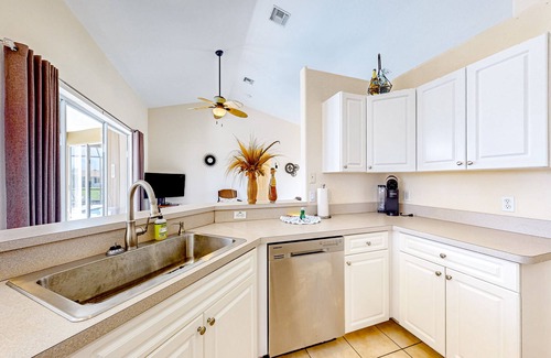 Cape Coral House | Waterfront home with screened pool, patio, grill, foosball, AC, & W/D