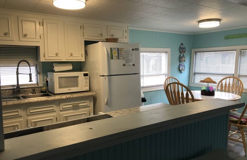 Surfside Beach Cottage | Waterfront, Large deck, Pet friendly, Golf cart, Screened in porch.