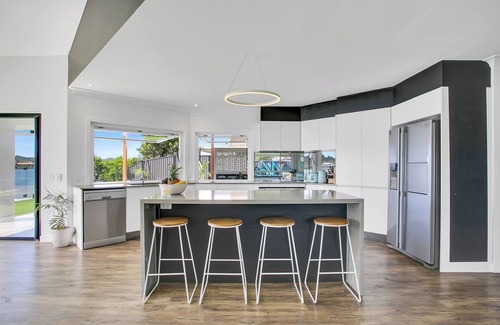 Elanora House | Waterfront Retreat with Infinity Pool & Canal Views