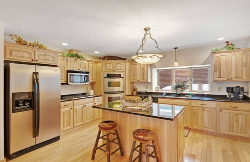 Eagle River House | Waterfront townhome with fireplace, private patio, & shared boat docks