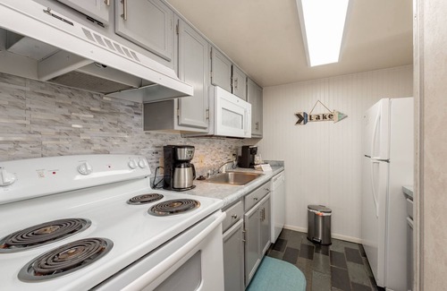Thayerville Condo | Will O' The Wisp 304C: Lakefront One Bedroom Condo with Fireplace & Balcony!