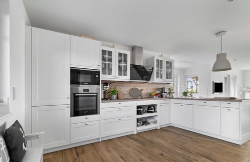 Olpenitz House | Wooden holiday home "Bootshaus" with sauna, bathing jetty and south-facing terrace with Baltic Sea view