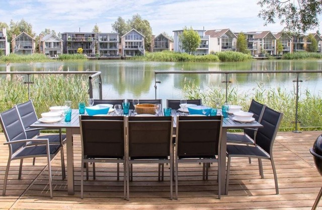 A contemporary glass fronted lake side home that sleeps 10 guests in 5 bedrooms