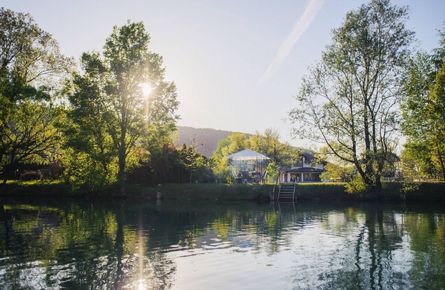 A modern Villa with a spacious yard ending with a beach on the river Una.
