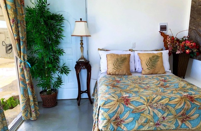 Adorable tropical room with a stunning balcony, pool, fire pit, gardens, & more!