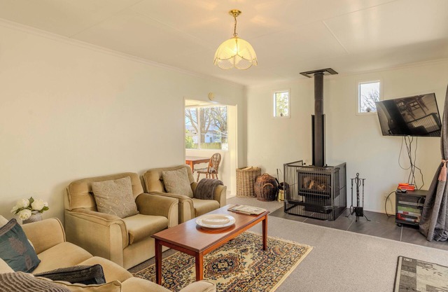 Amongst trees is this quaint cottage & within a 5-minute walk to town & beach