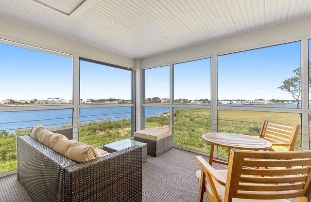 Bay view condo with screened porch, central AC, on-site golf and shared pool