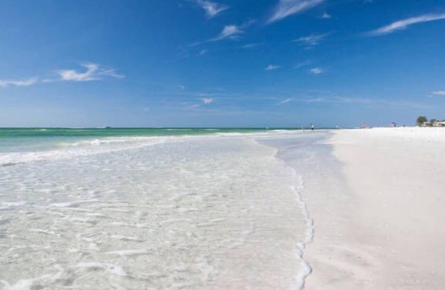 Beachy villa on Siesta Key with heated pool, screened in lanai, and ground level